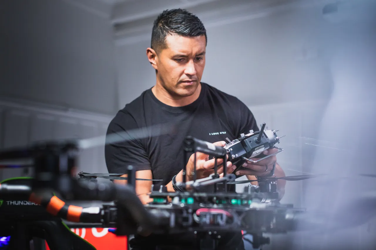 Man working on drone inside
