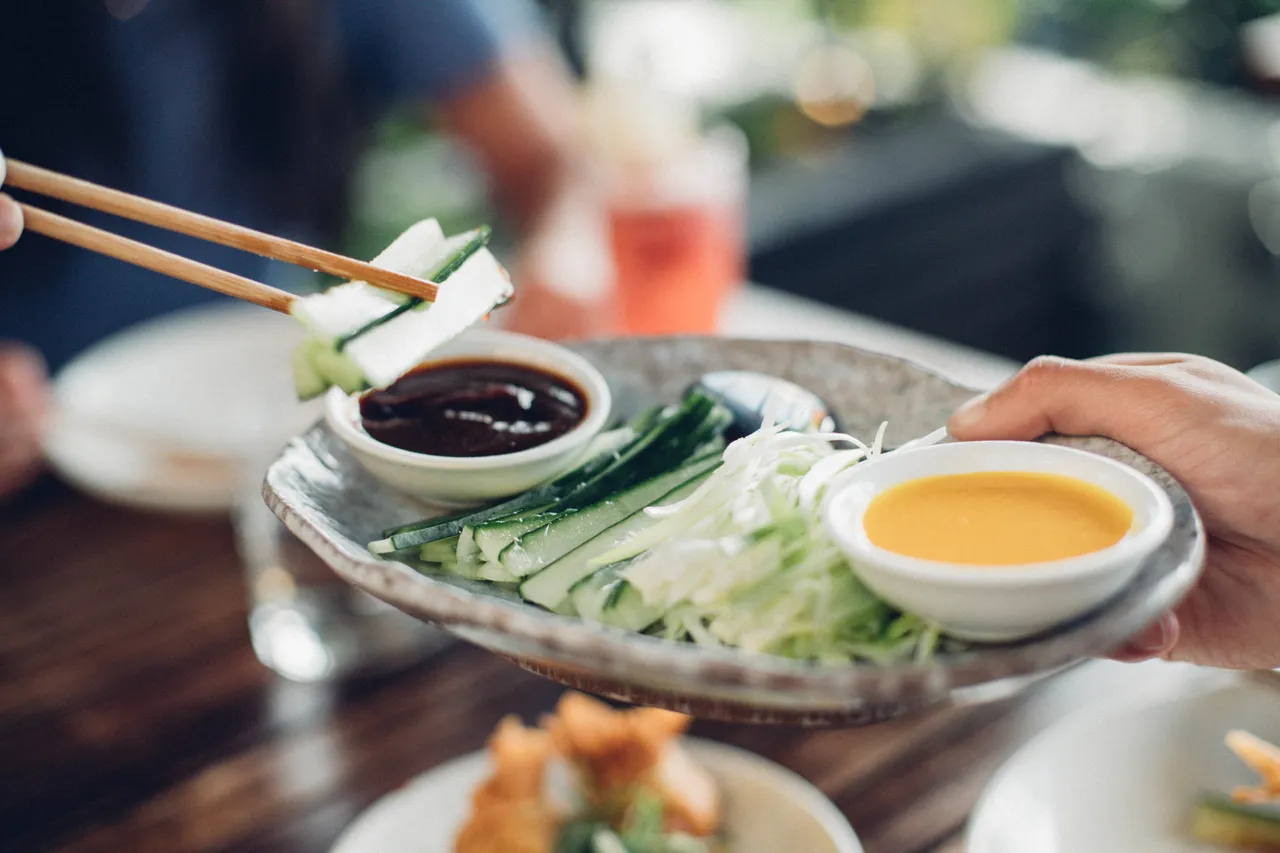 Chopsticks reaching for food