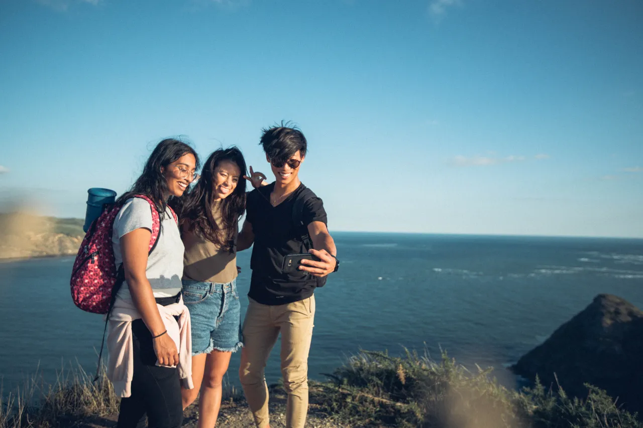 Group of people taking a selfie on a cliff top