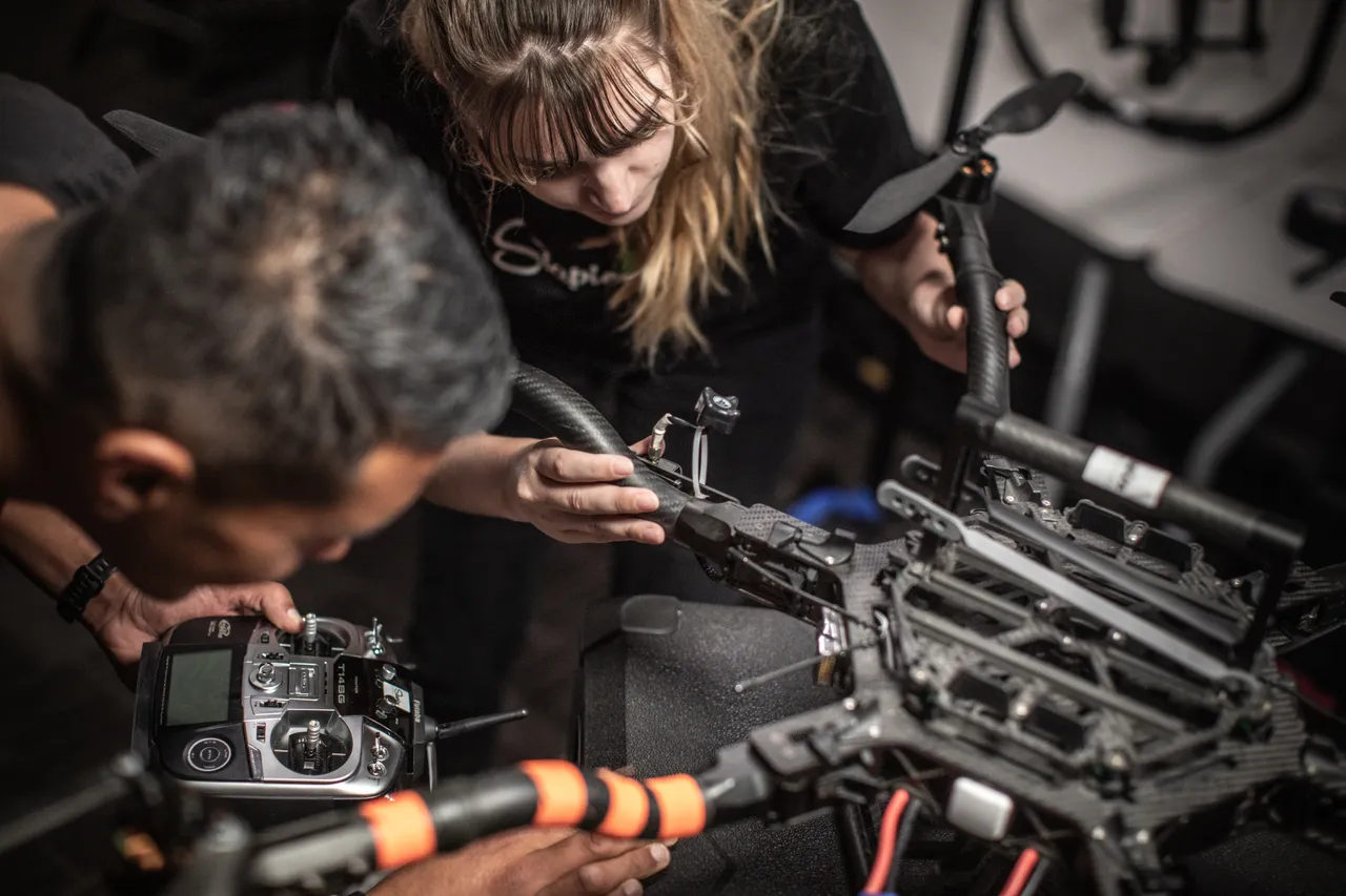Woman and man setting up drone close up