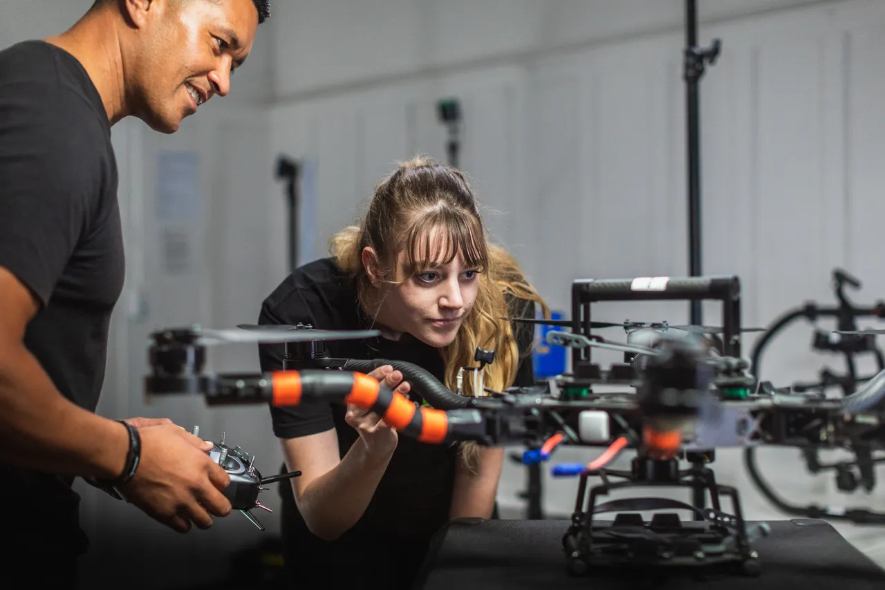 Man and woman working on drone