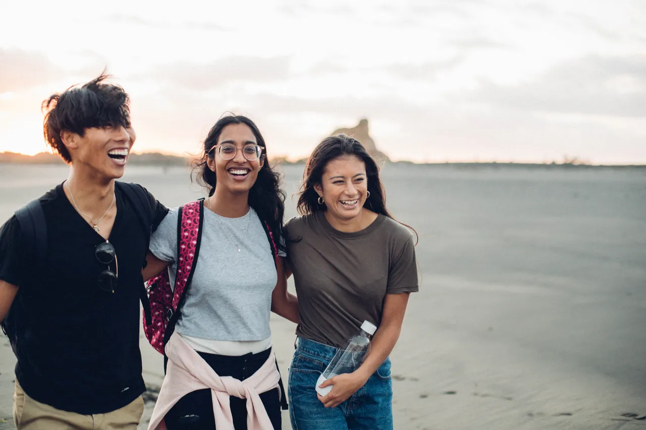 Students smiling on beach