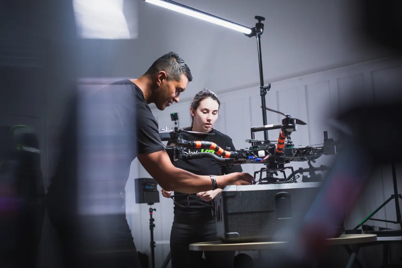 Man and woman setting up aerial drone
