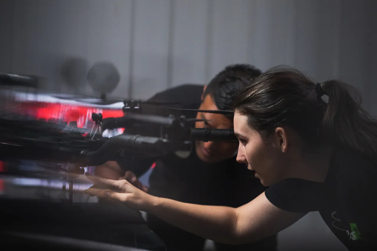 Man and woman setting up drone inside
