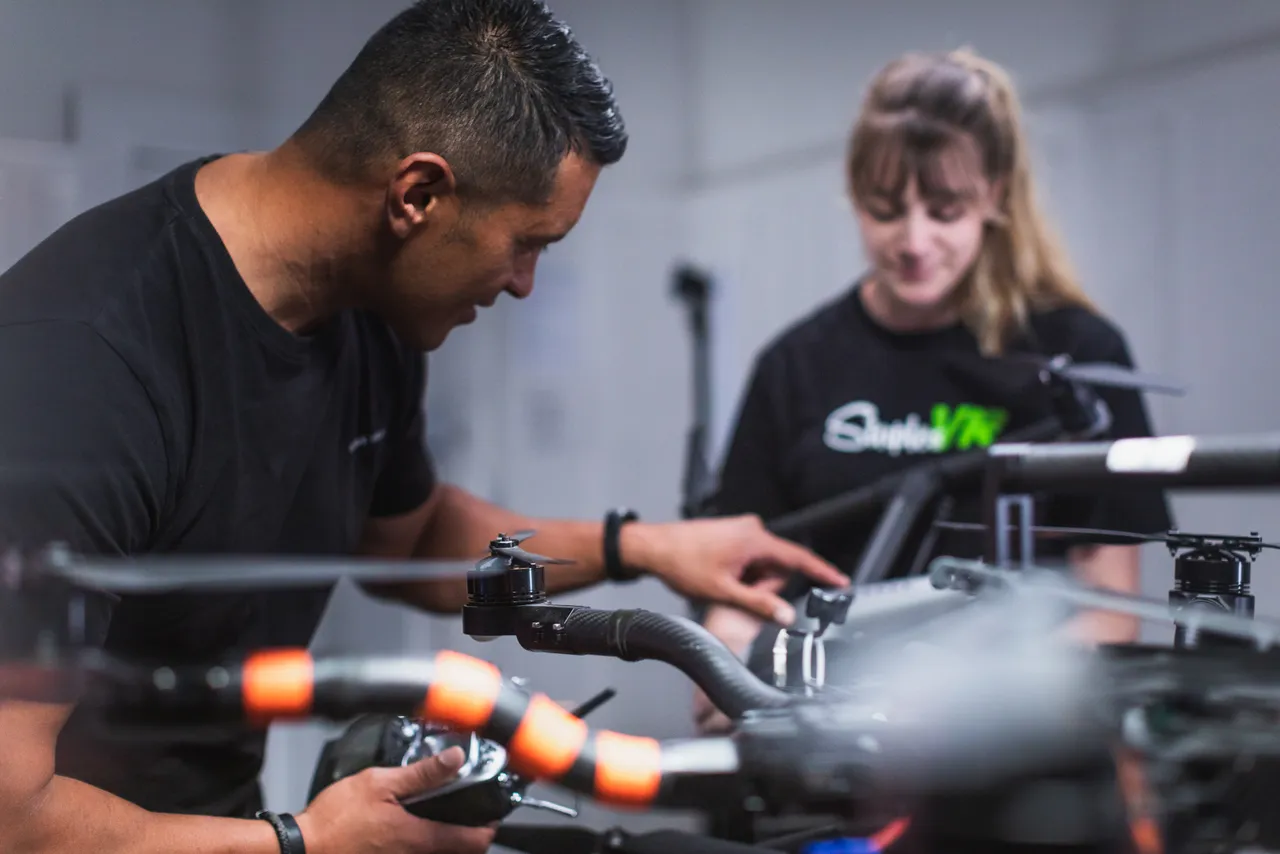 Man setting up drone woman in background