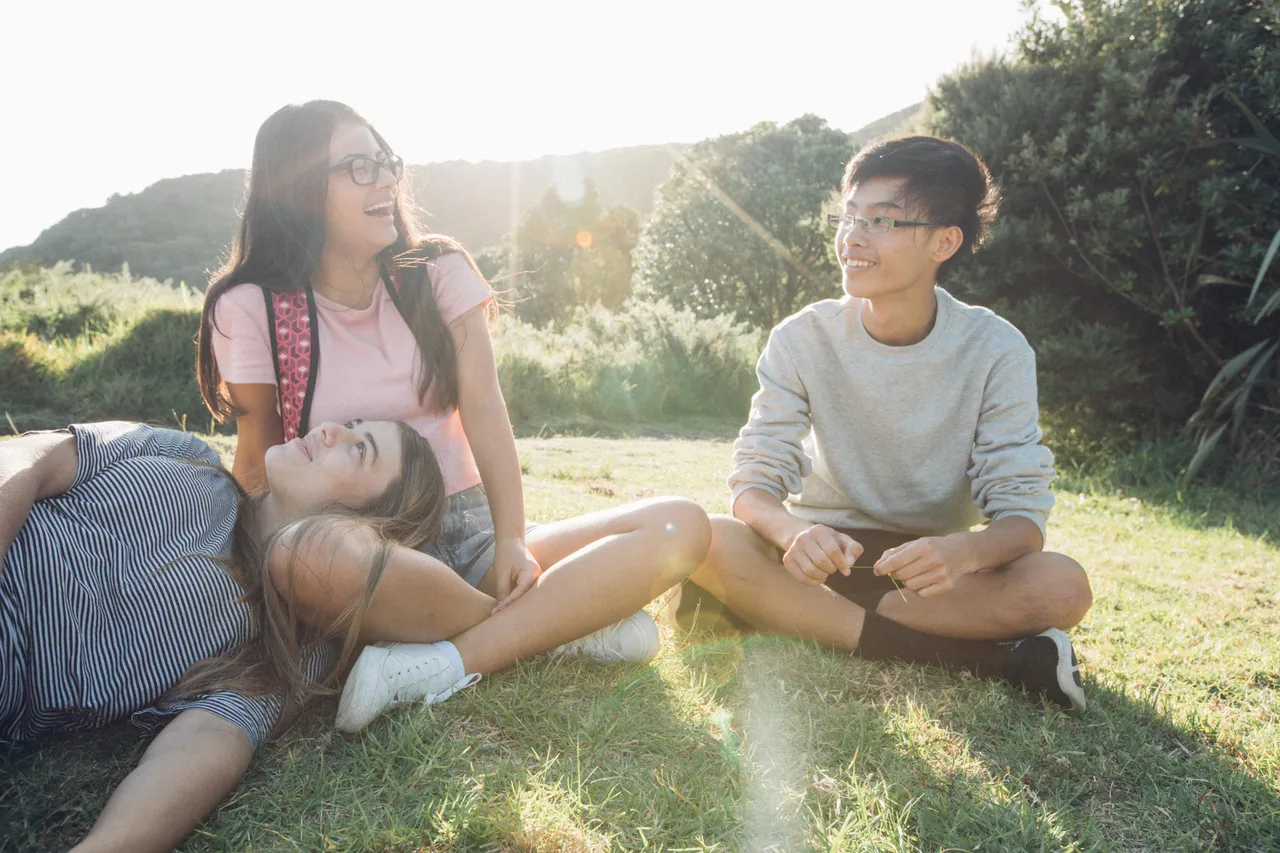 Students sitting on grass interacting