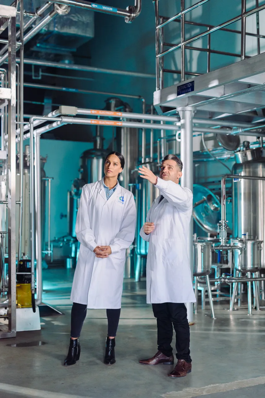 Man and woman talking in a factory