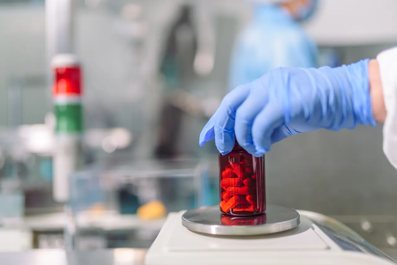 Pills in bottle at production facility