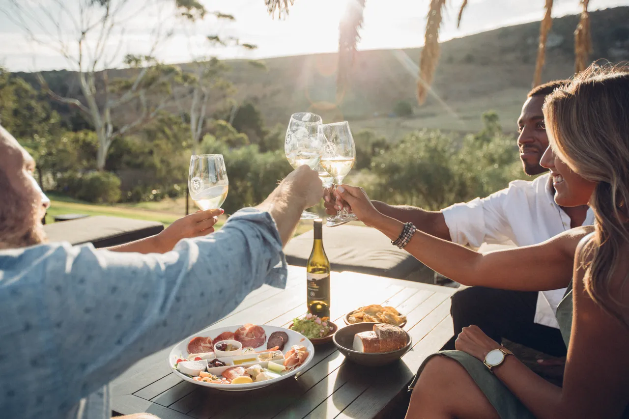 Friends toast their glasses at Stonyridge vineyard
