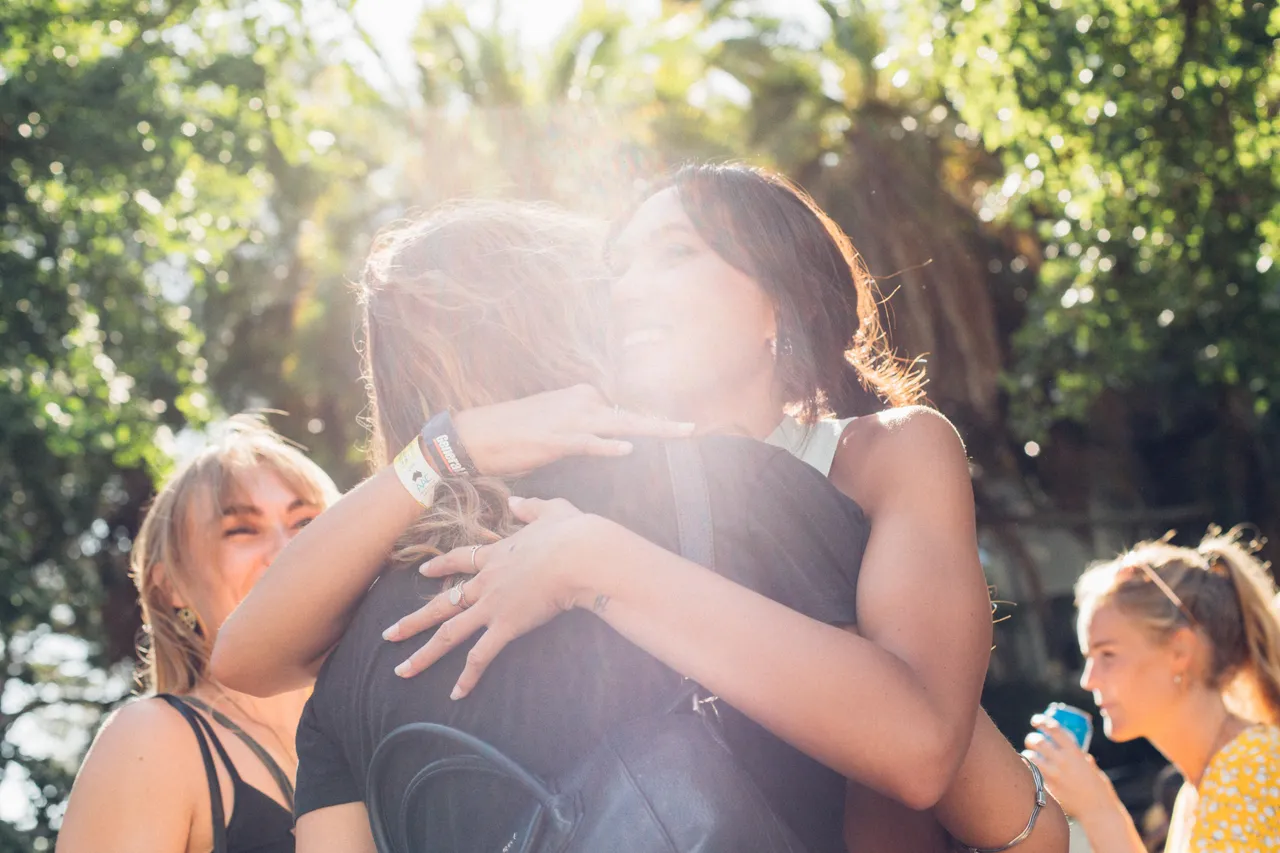 Friends hugging in a park in Auckland