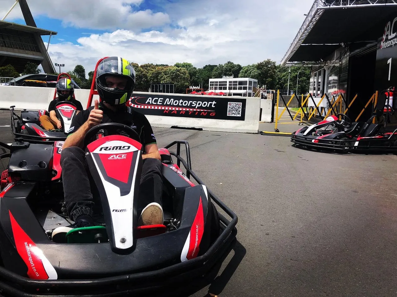 Go Kart racer giving a thumbs up after completing a race at Ace Motorsport