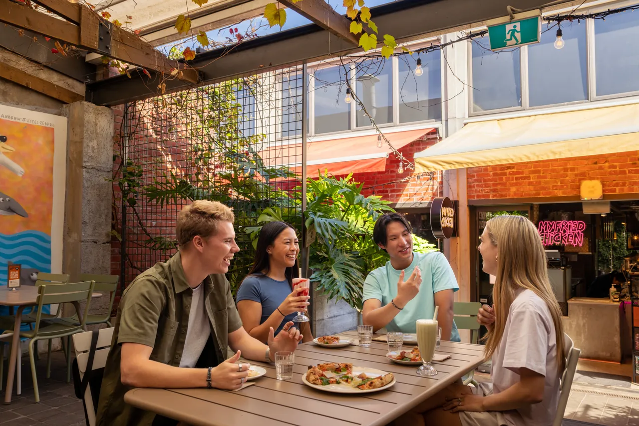 Friends eating at Eat Street Takapuna