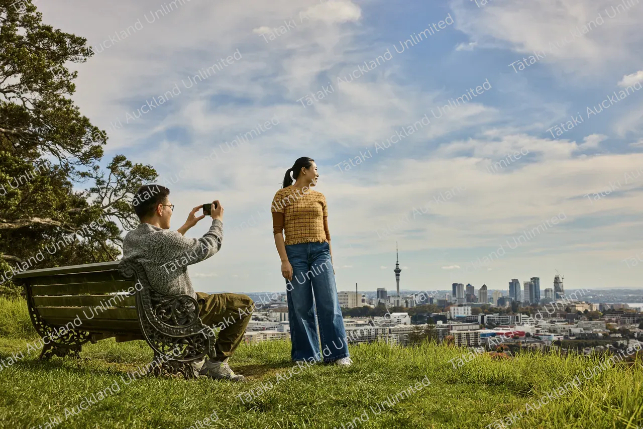 Couple admires the city view from Ōhinerau Mt Hobson 3
