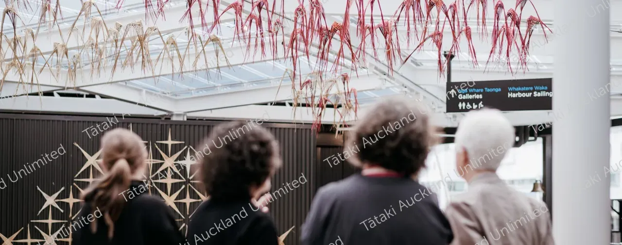 Woven art installation with people in foreground