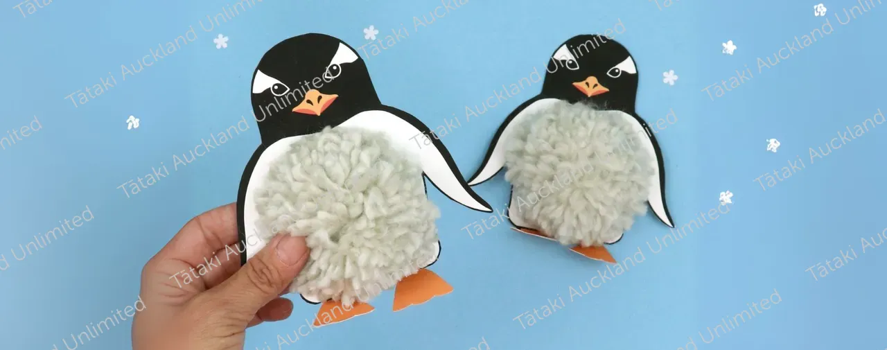 penguin craft activity on blue background