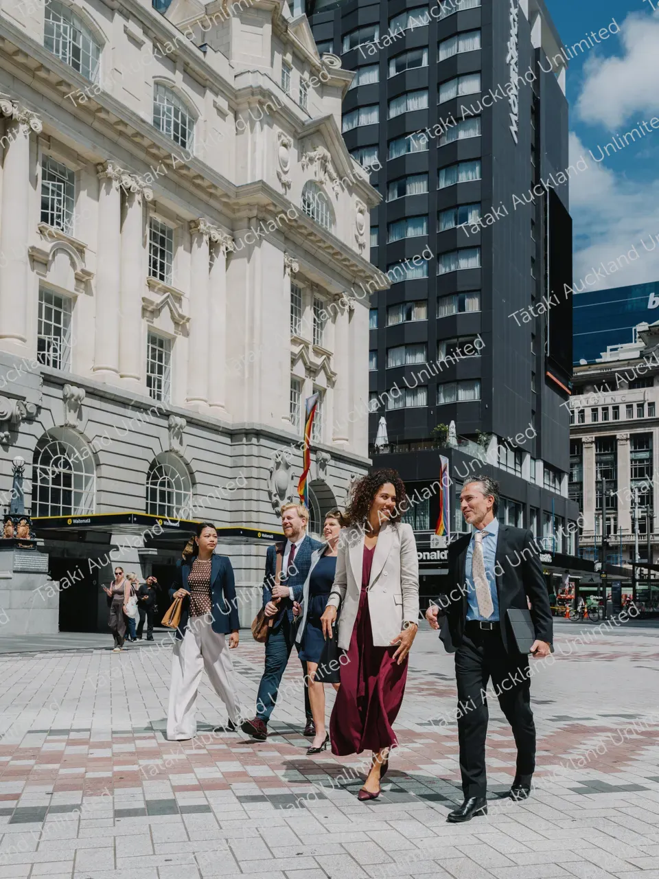 Business professionals walk across Te Komititanga Square 13