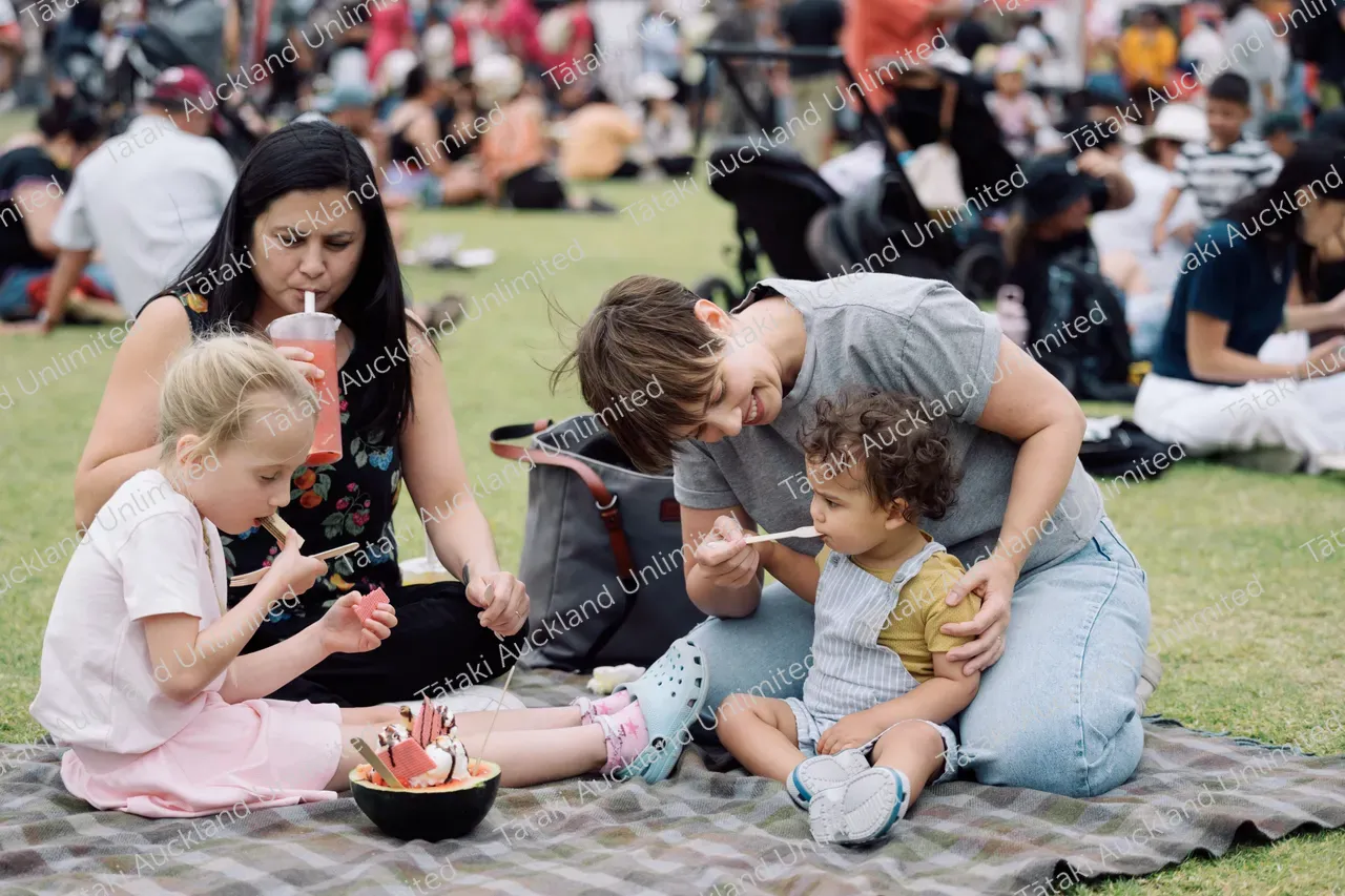 Family enjoys food at Pasifika Festival