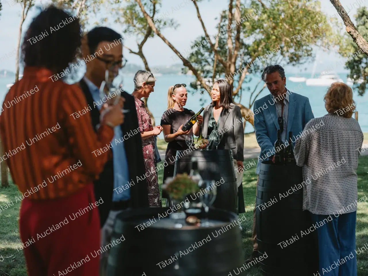  A group of business professionals wine tasting at a Waiheke vineyard 