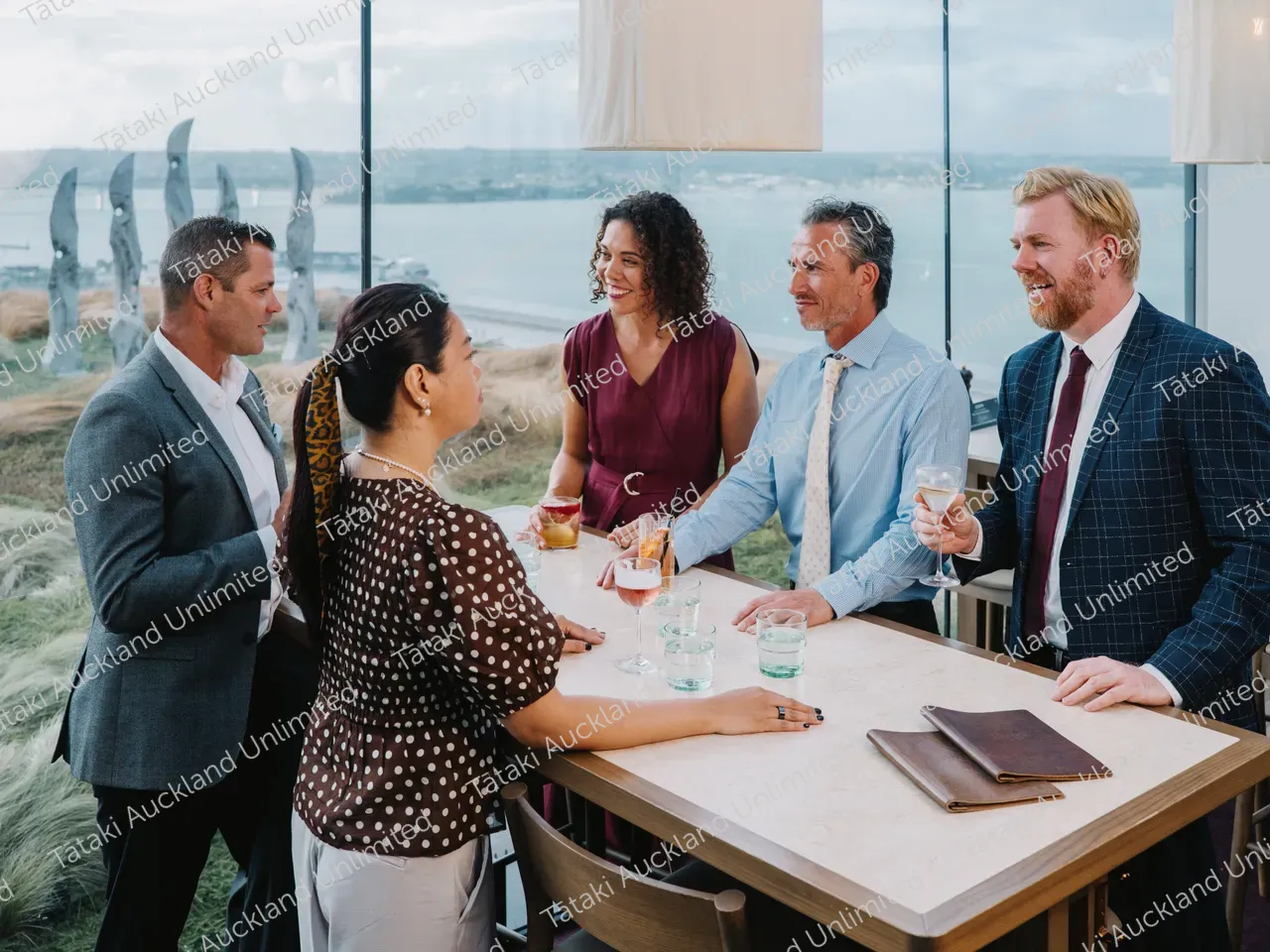 Five business professionals share a rooftop terrace meal 5