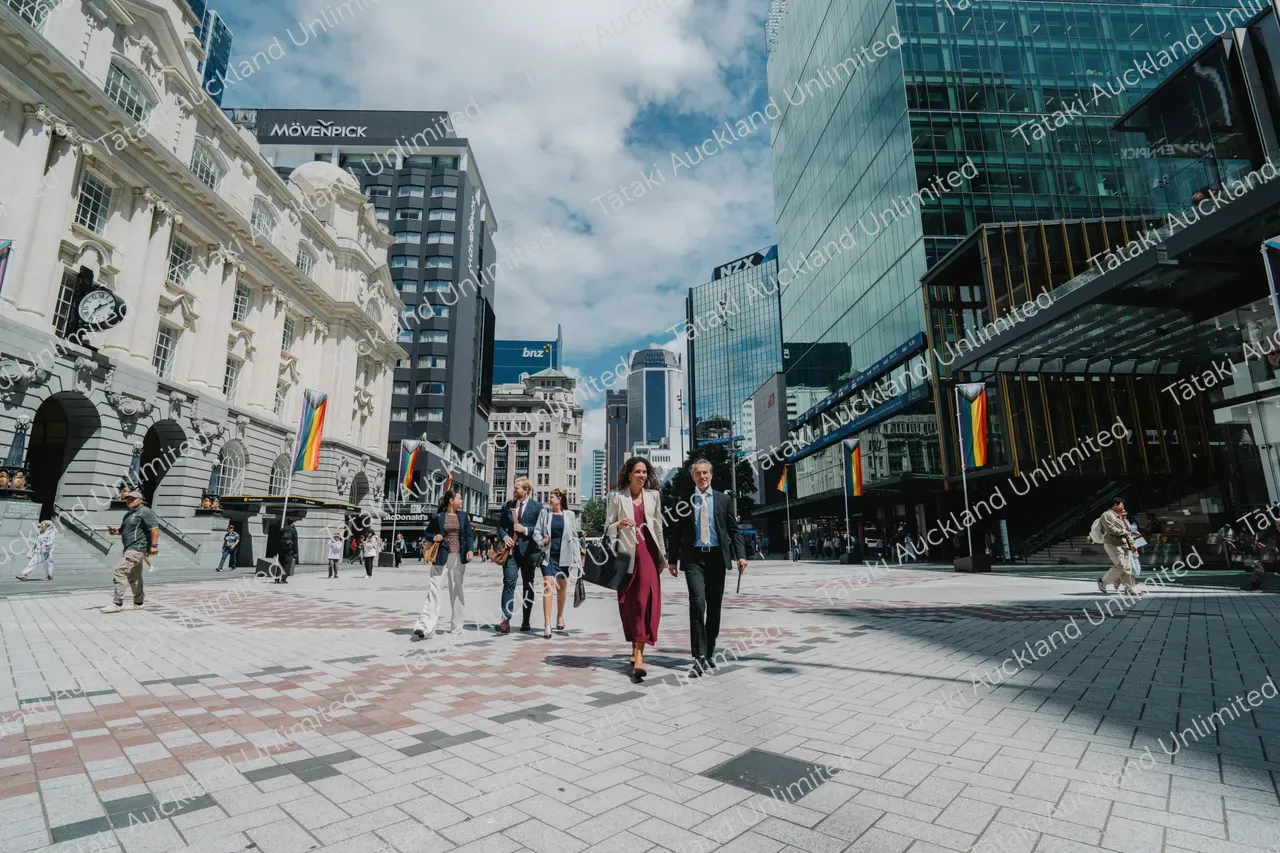Business professionals walk across Te Komititanga Square 9