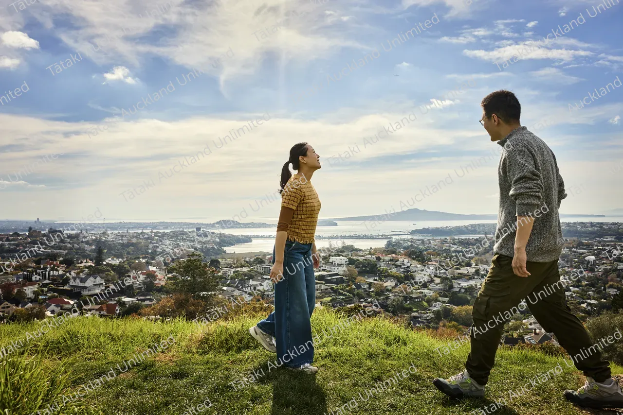 Couple admires the city view from Ōhinerau Mt Hobson