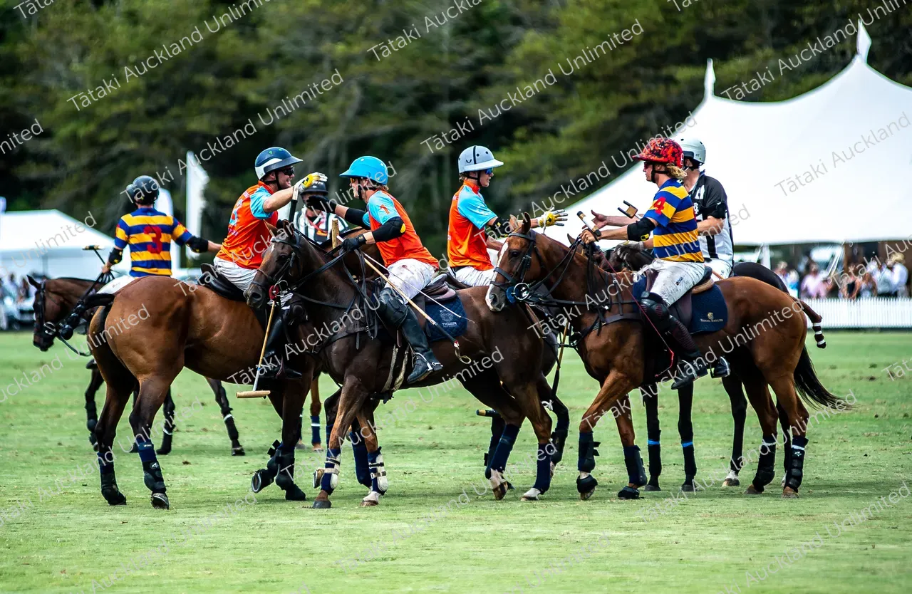 Polo players on horseback meet on the field during a match.