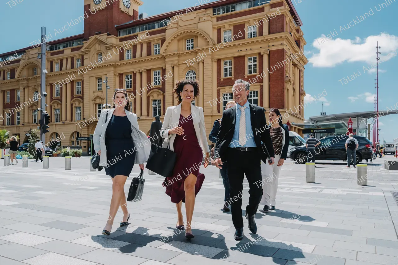 Business professionals walk across Te Komititanga Square 8