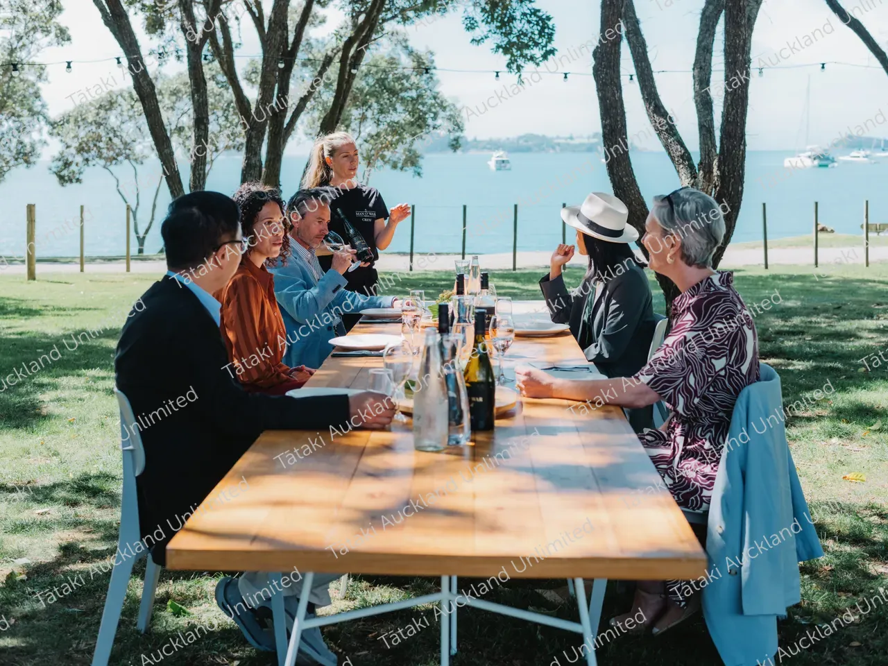 Business professionals dine outdoors at Waiheke vineyard 2