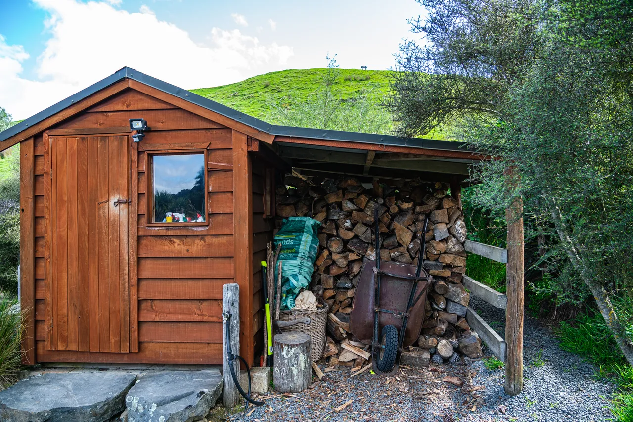 Shed with firewood and wheelbarrow