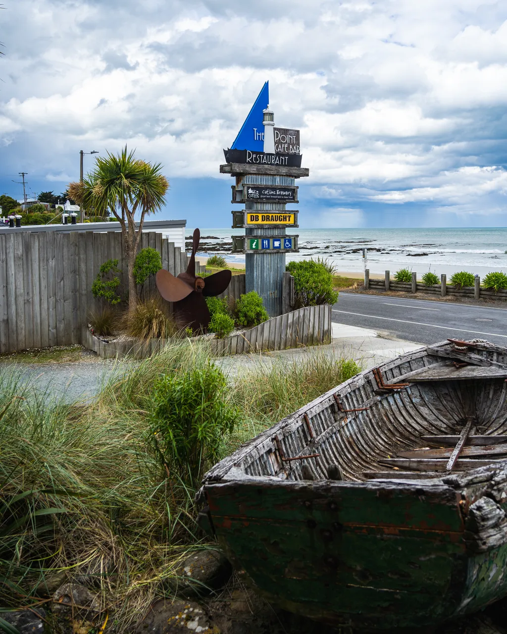 Signs and old wooden boat
