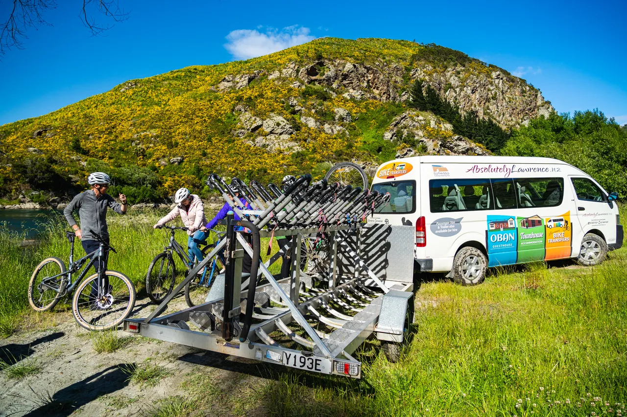 Shuttle van with bikes and people