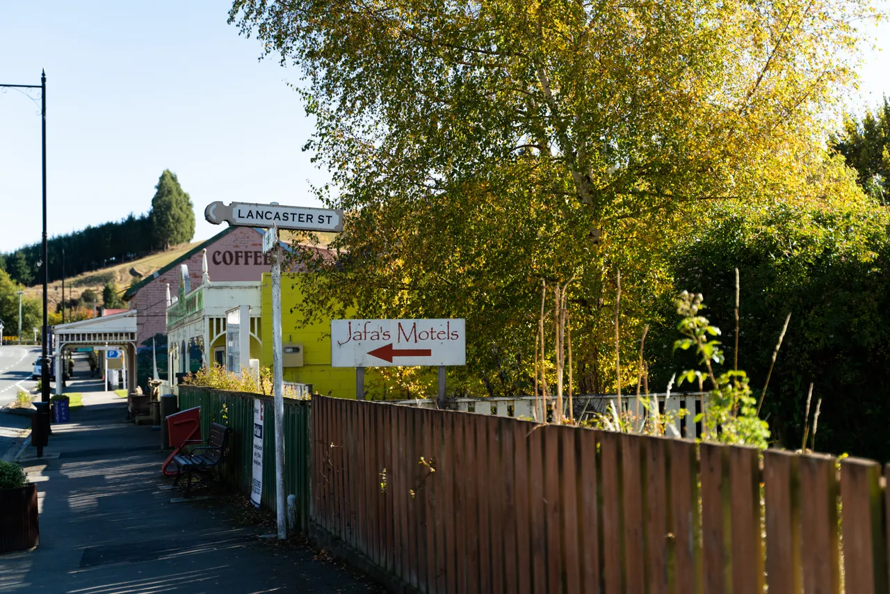 Road signs and wooden fence