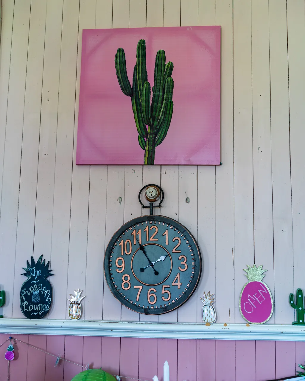 Clock and cactus artwork