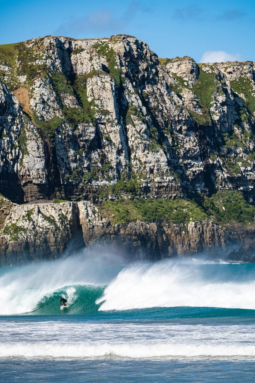 Sea and cliffs and surfer