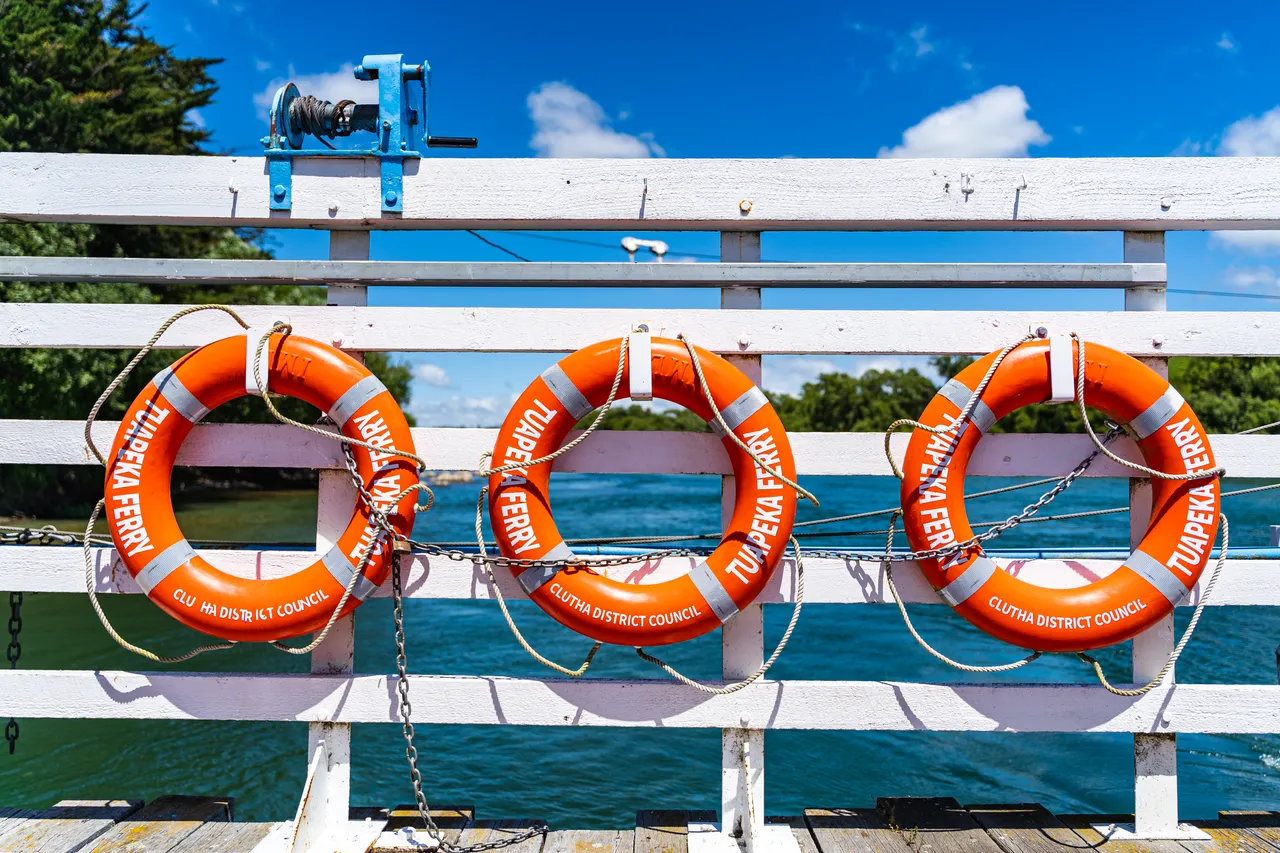 White fence and orange lifebuoys