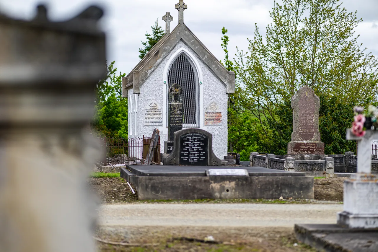 White building and headstones