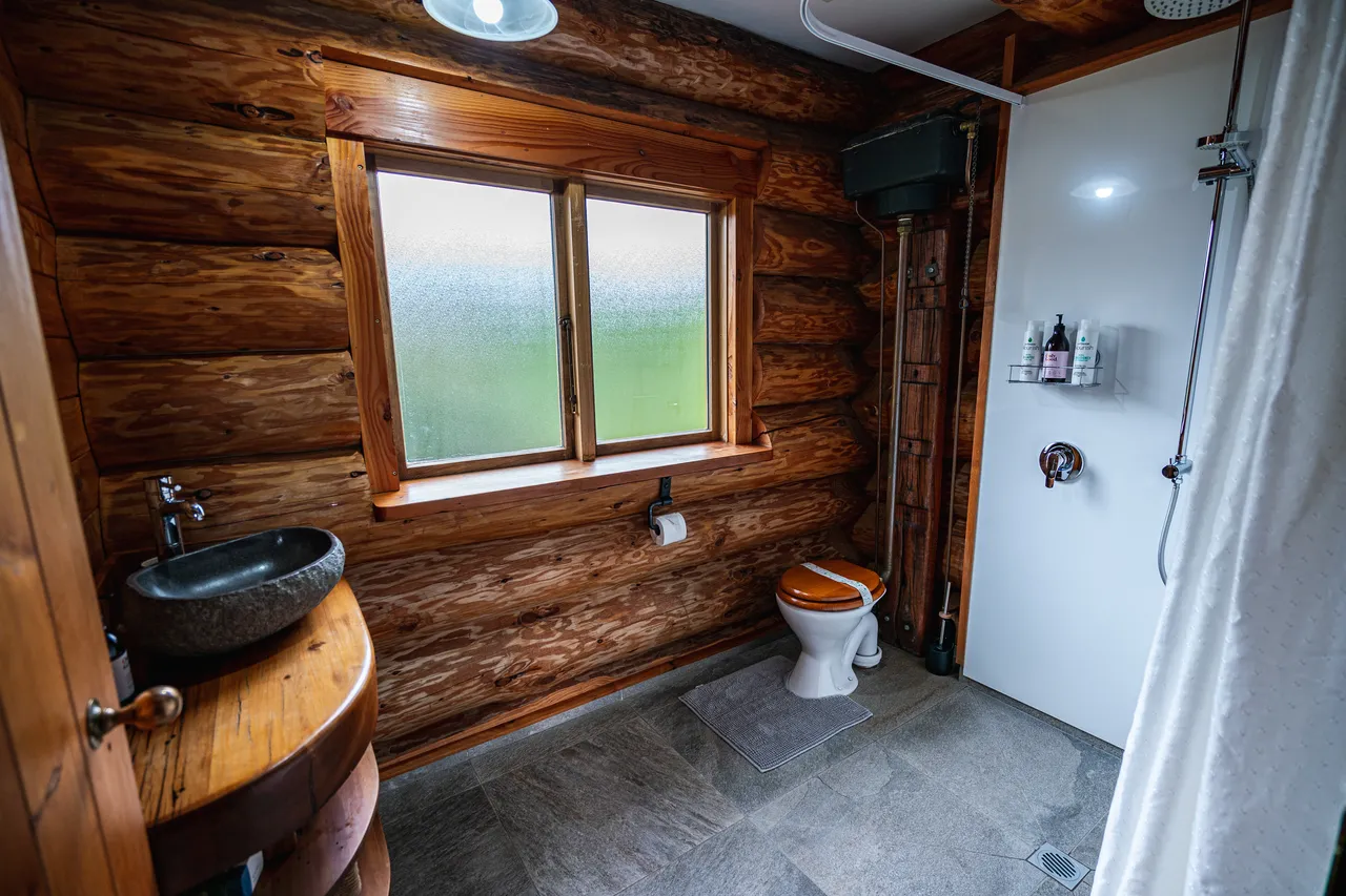 Rustic bathroom with open shower