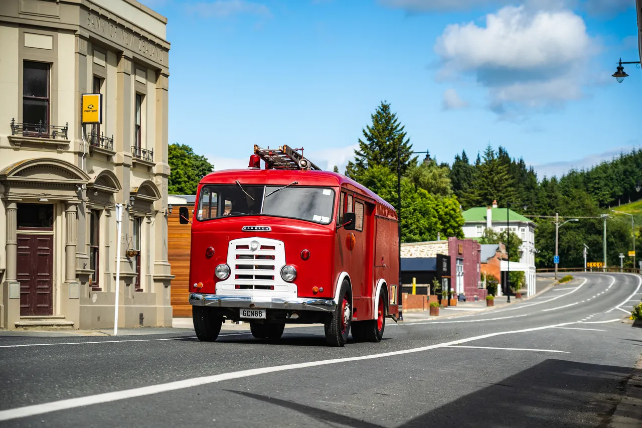 Old firetruck driving through Lawrence
