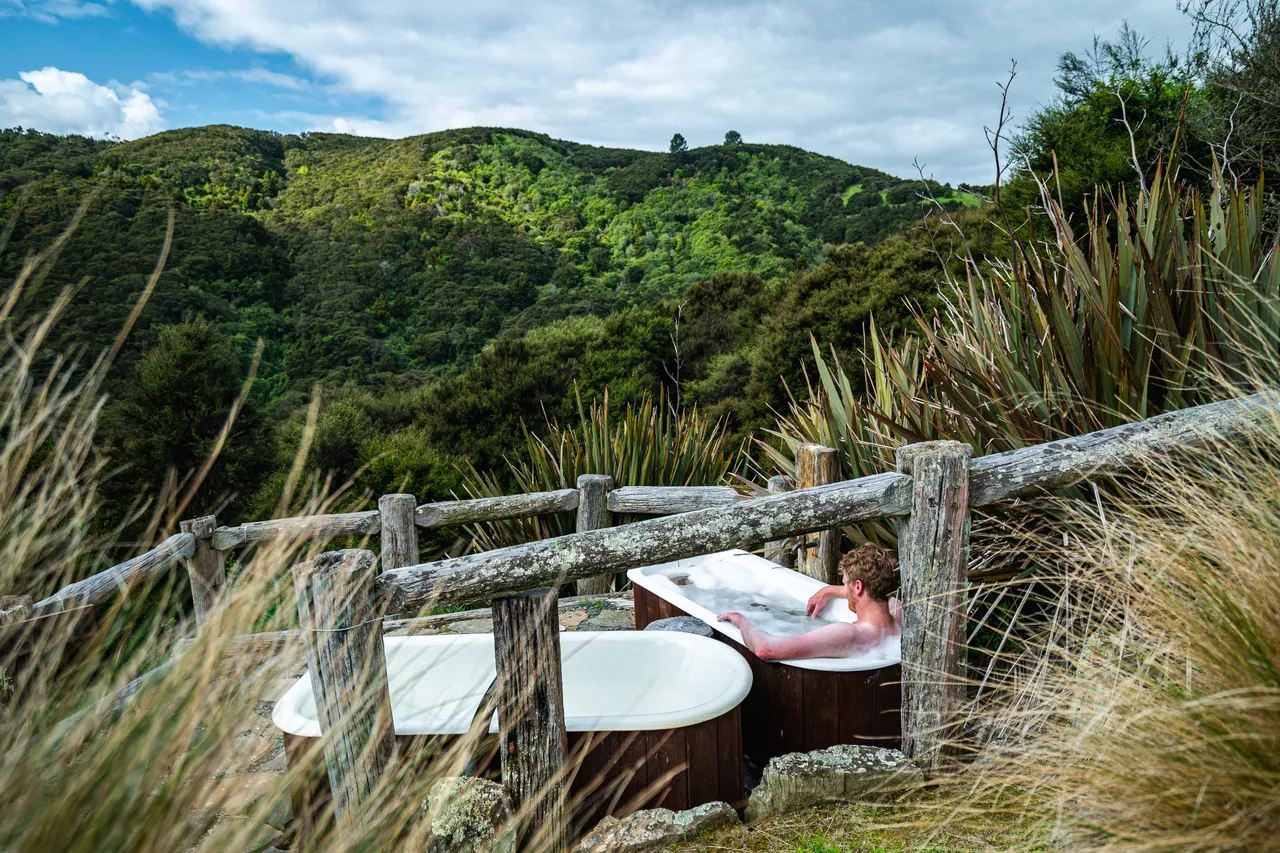 Person in bathtub outside