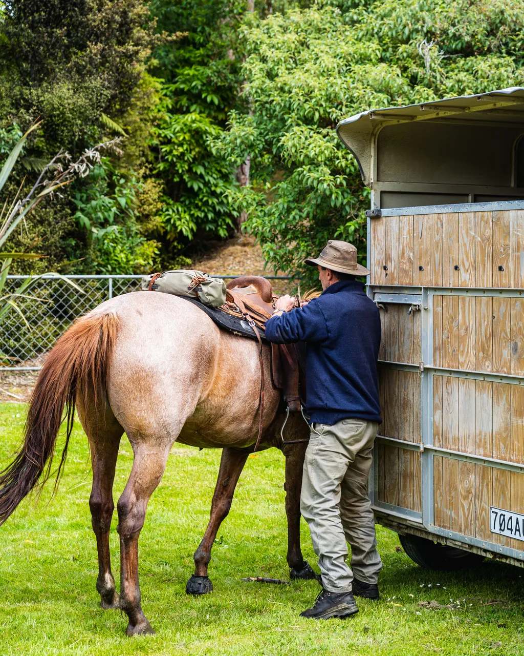 Man with horse beside horse float