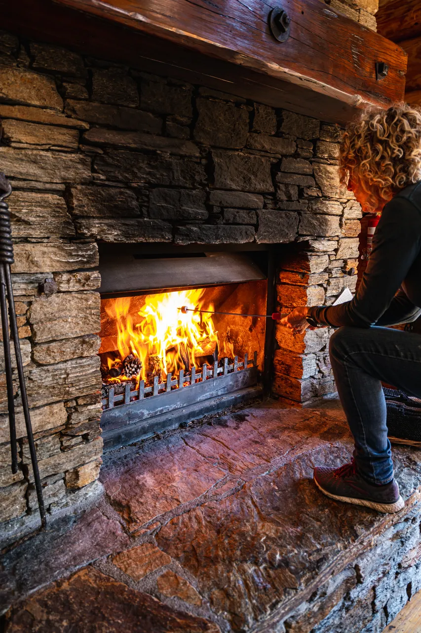 Person roasting marshmallows on the fireplace