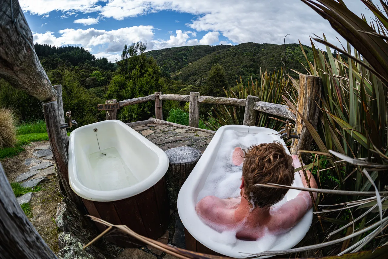 Person in bathtub outside