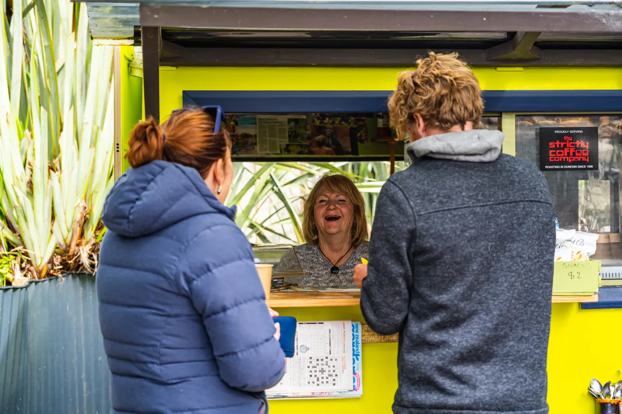 People standing beside coffee cart