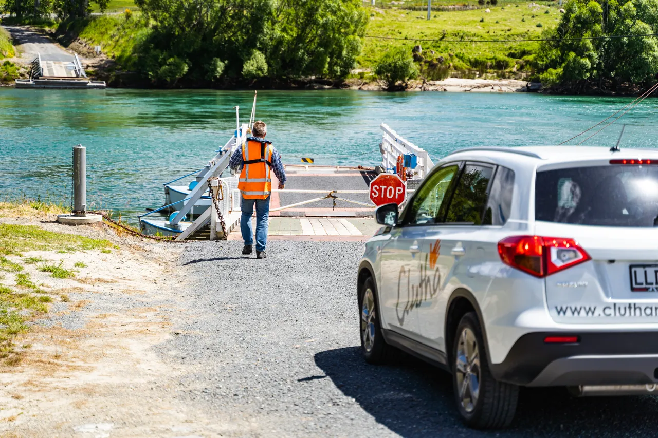 Tom Jones and car on road beside the river