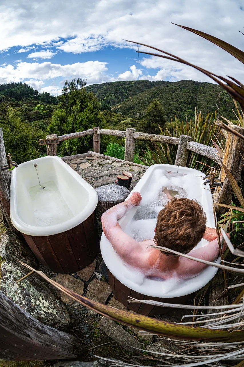 Person in bathtub outside