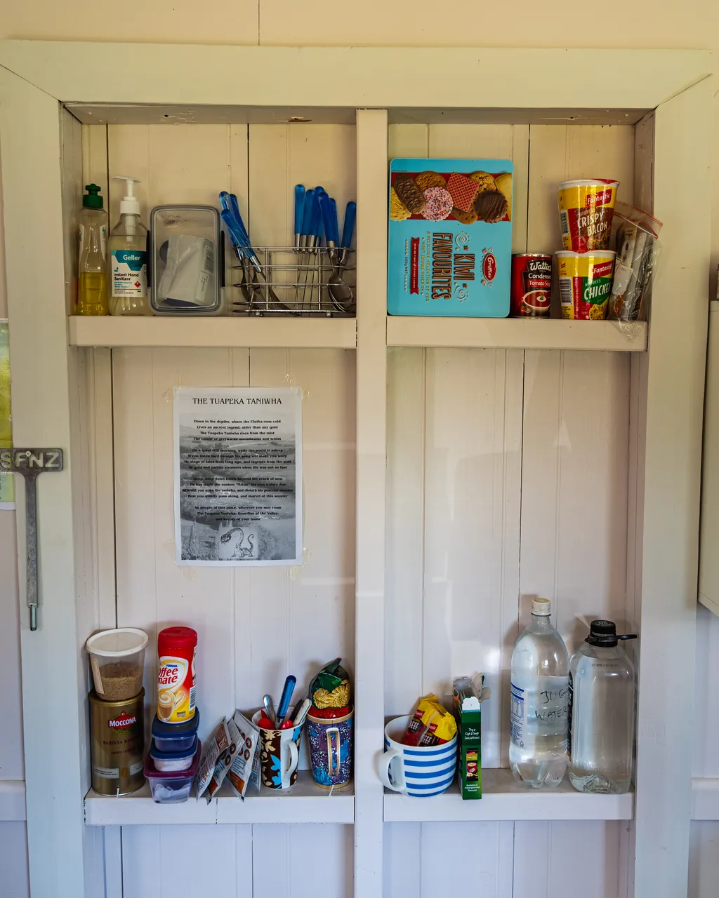 Cupboard with food and mugs