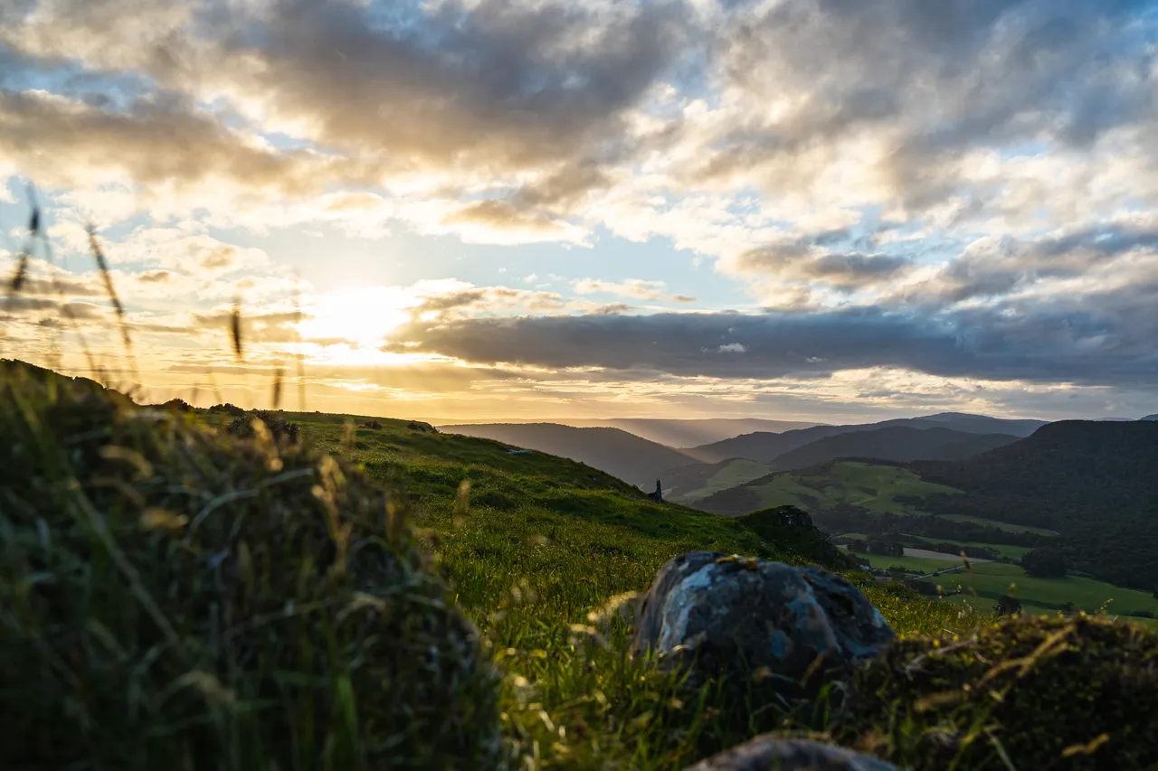 A view of farmland with clouds and sunset
