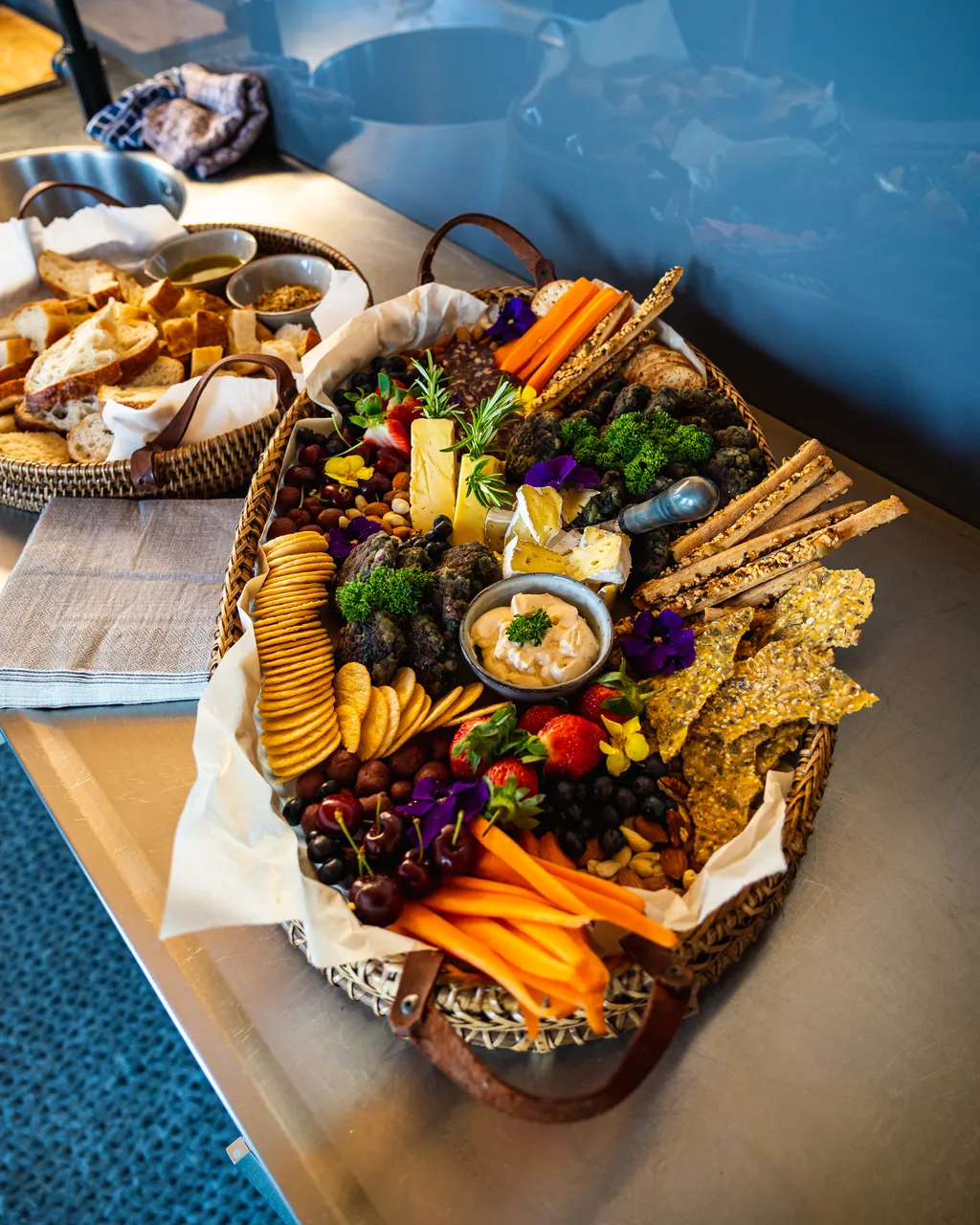 i.e. a platter with cheese, crackers, dips, and carrots sitting on a coffee table.