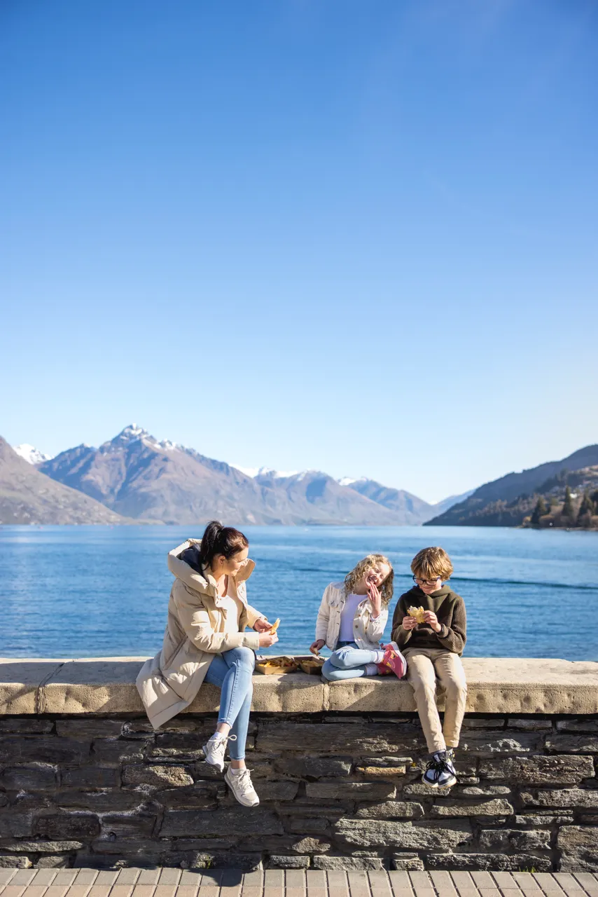 Family eating fish and chips at waterfront