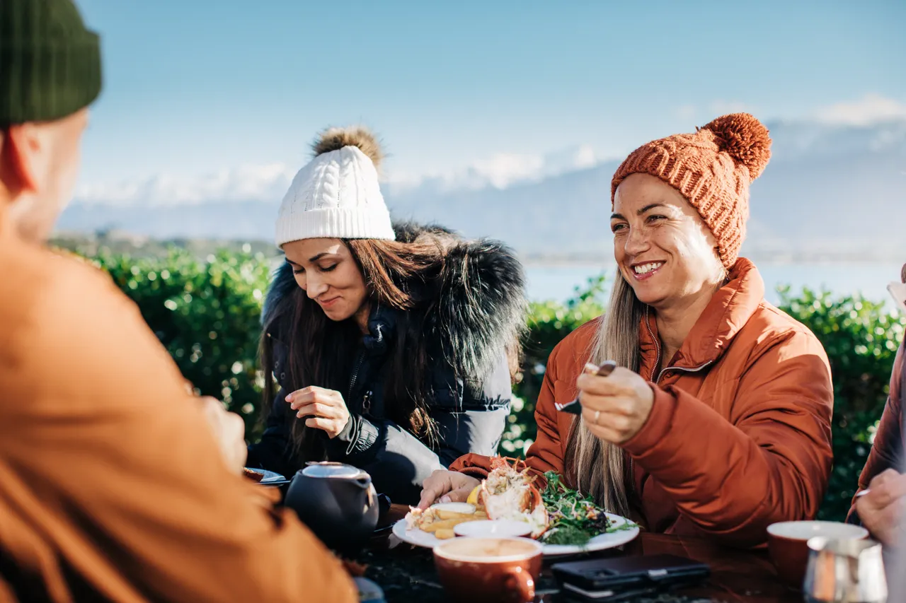 A group of friends enjoying a stopover in Kaikoura on a sunny winter day